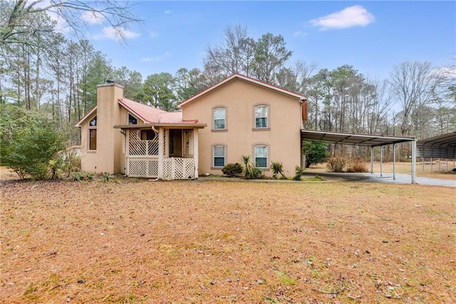 rear view of property with a carport