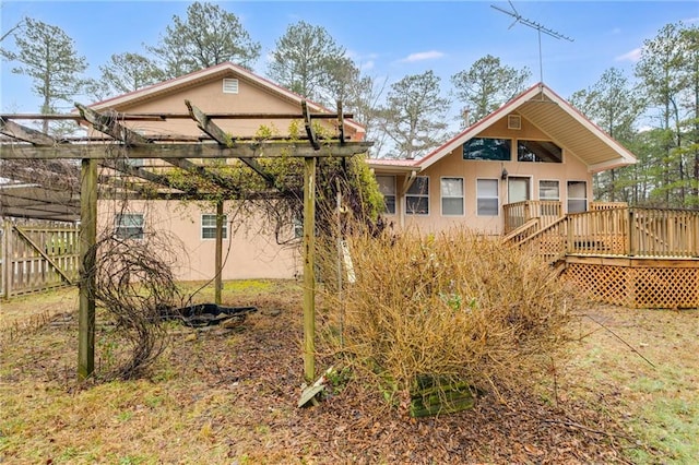 back of house featuring a wooden deck