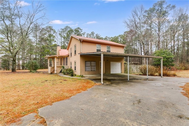 exterior space featuring a garage, a carport, and covered porch