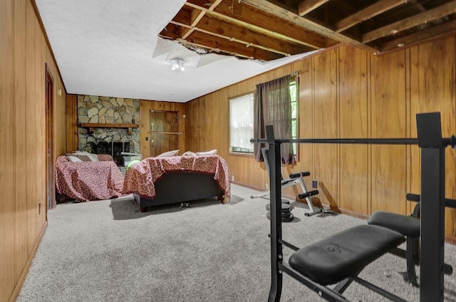 504 Rock Meadow Dr, Stone Mountain, GA 30088 - carpeted bedroom with wood walls and a stone fireplace