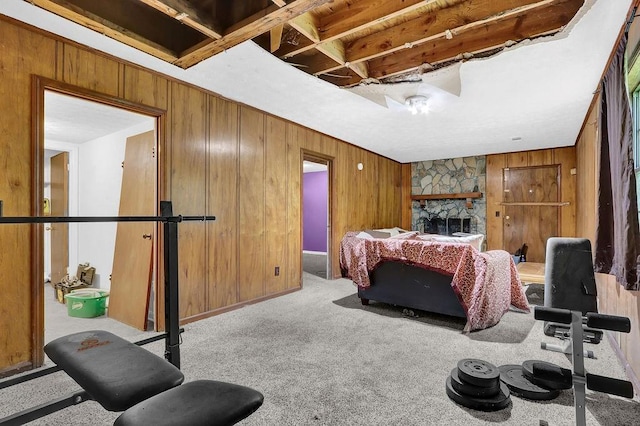 504 Rock Meadow Dr, Stone Mountain, GA 30088 - bedroom featuring wood walls, carpet, and a fireplace