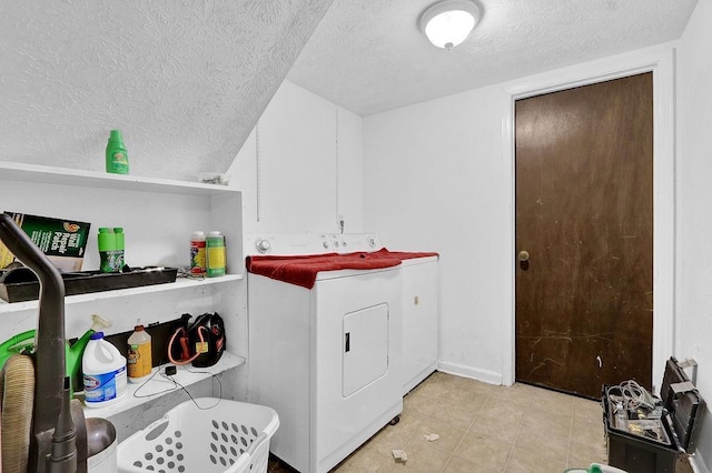 504 Rock Meadow Dr, Stone Mountain, GA 30088 - washroom featuring a textured ceiling, washer and clothes dryer, and light tile patterned flooring