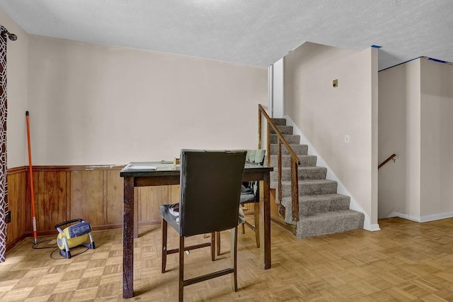 504 Rock Meadow Dr, Stone Mountain, GA 30088 - dining area with a textured ceiling, wainscoting, stairway, and wood walls