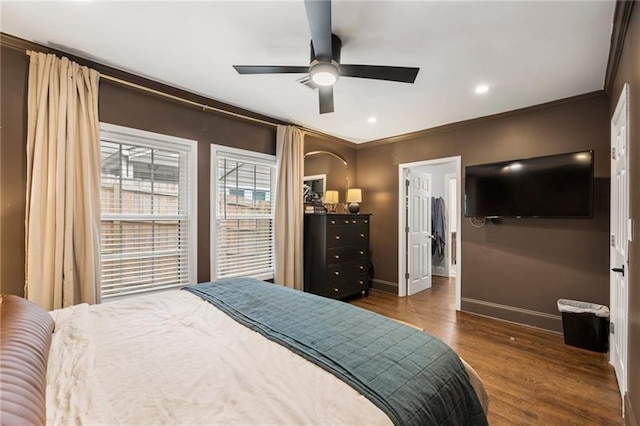 bedroom with ceiling fan, dark hardwood / wood-style flooring, and ornamental molding