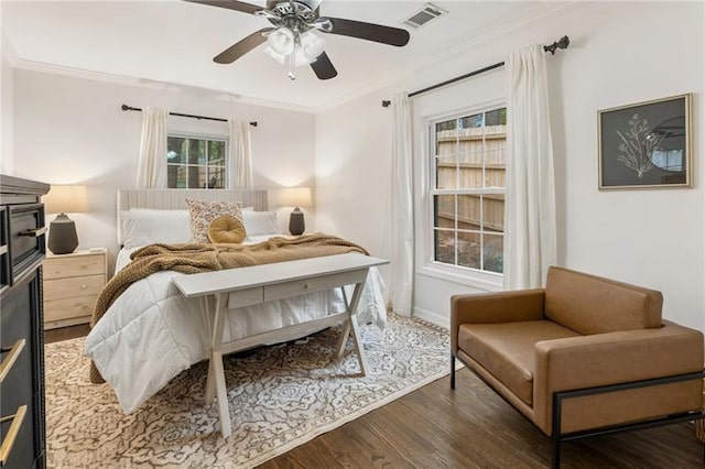 bedroom featuring ceiling fan, crown molding, and dark wood-type flooring