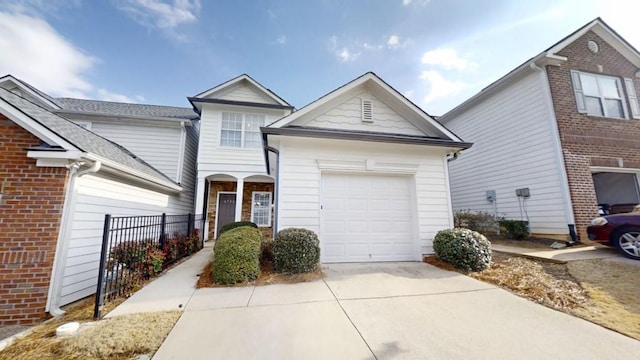 view of front facade featuring brick siding, driveway, and an attached garage