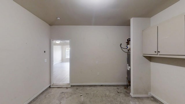 clothes washing area with baseboards