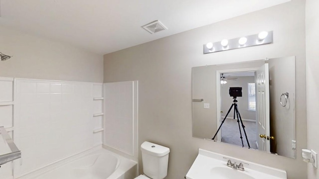 bathroom featuring shower / washtub combination, visible vents, vanity, and toilet