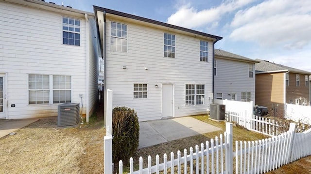 rear view of property featuring fence private yard, central AC, and a patio