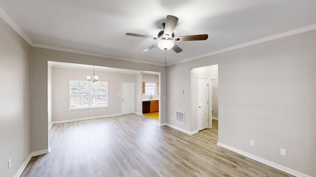 spare room with visible vents, ceiling fan, light wood-style flooring, and baseboards