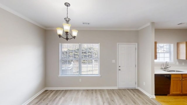 unfurnished dining area with light wood-style floors, baseboards, visible vents, and a sink