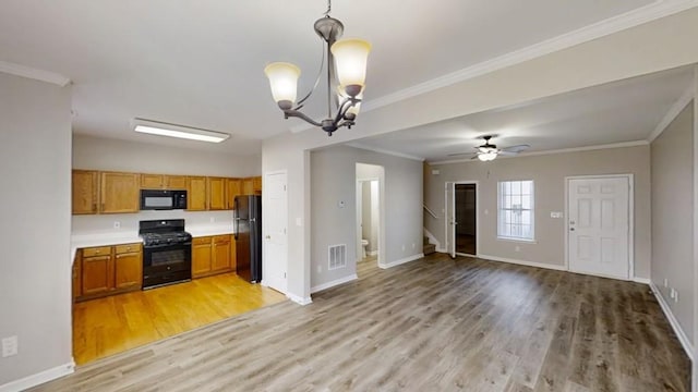 kitchen featuring visible vents, open floor plan, brown cabinets, black appliances, and crown molding