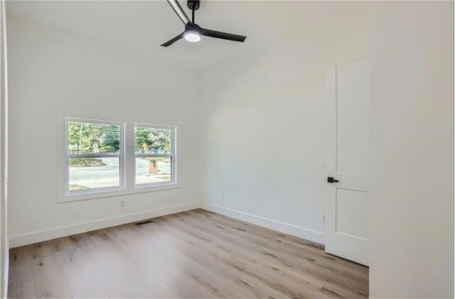 spare room featuring light wood-type flooring and ceiling fan