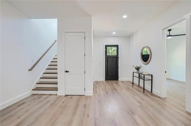 entrance foyer with ceiling fan and light hardwood / wood-style floors