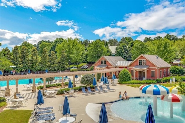 pool featuring a patio, a water play area, and a pergola