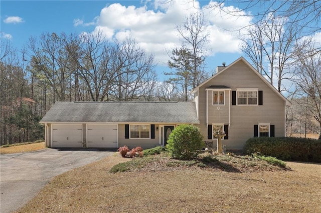 traditional home with aphalt driveway, a chimney, and a garage