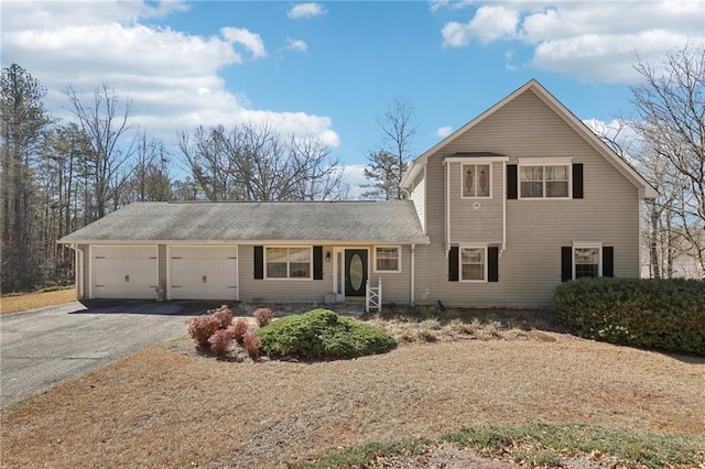 traditional-style home with aphalt driveway and an attached garage