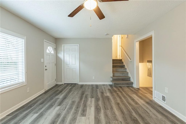 unfurnished bedroom with carpet, a textured ceiling, a closet, and ceiling fan