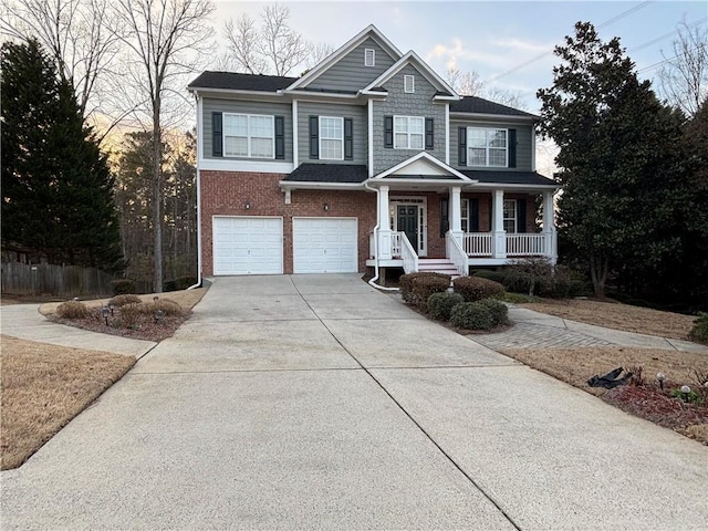 view of front facade with a porch, a garage, brick siding, fence, and driveway