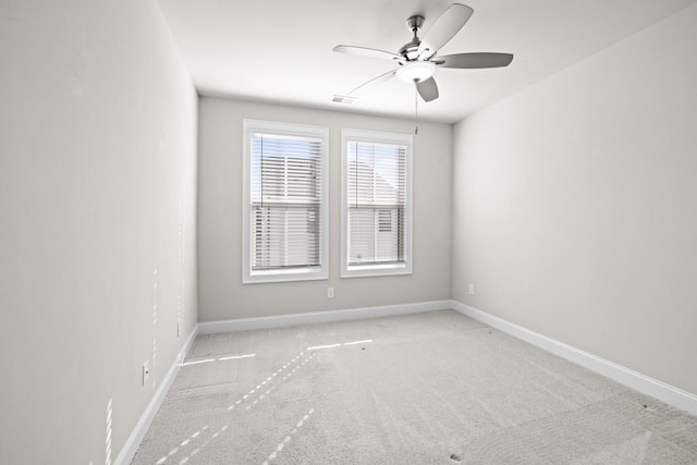 carpeted spare room featuring ceiling fan