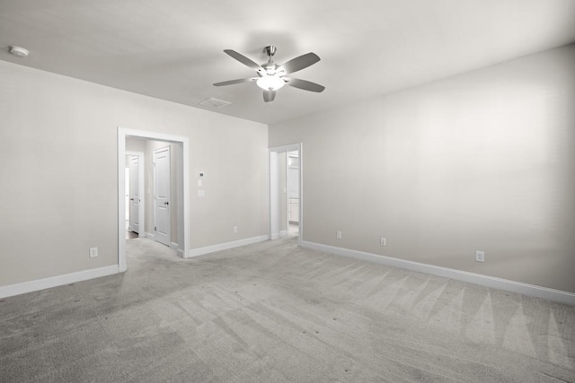 empty room featuring ceiling fan and light carpet