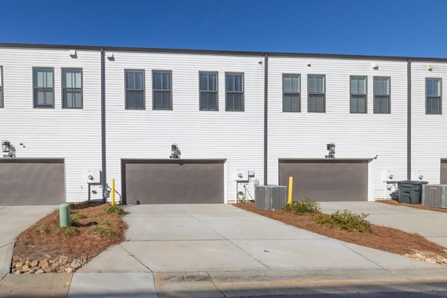 view of front facade with a garage and central air condition unit