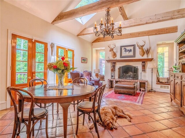 tiled dining room featuring a skylight, high vaulted ceiling, an inviting chandelier, and beamed ceiling