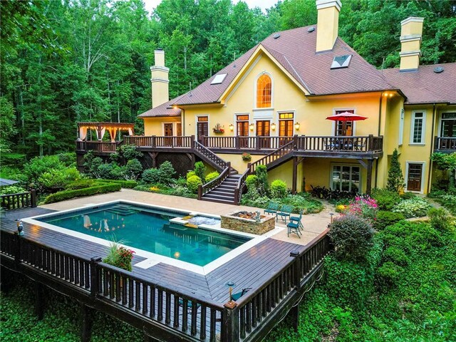 rear view of house featuring a patio area and a deck