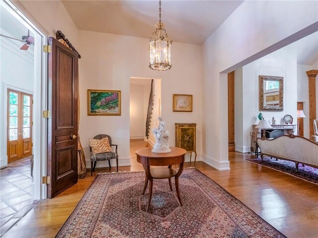 sitting room with light wood-type flooring and a notable chandelier