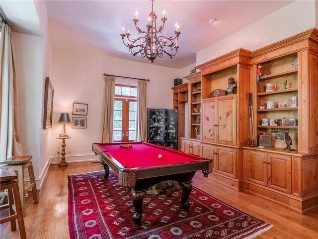 rec room with an inviting chandelier, pool table, and light hardwood / wood-style floors