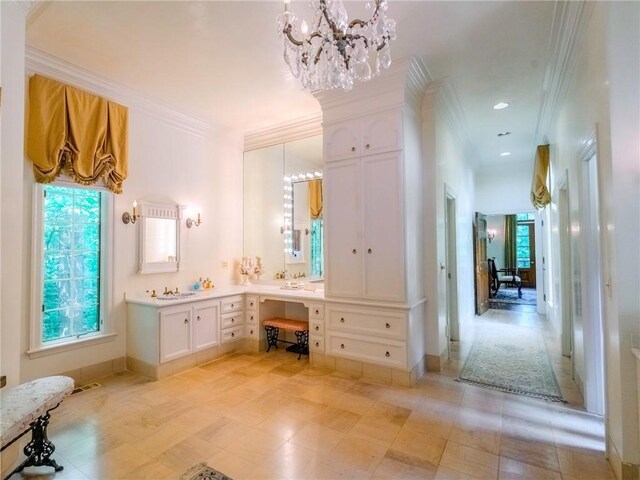 bathroom featuring ornamental molding, vanity, and a chandelier