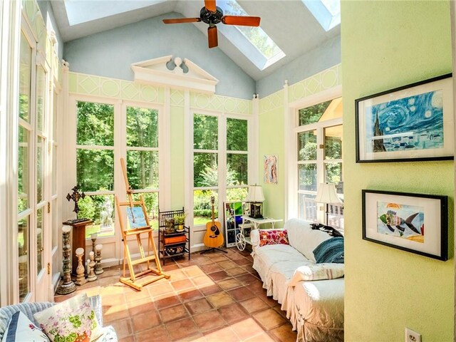 sunroom featuring ceiling fan, a wealth of natural light, and vaulted ceiling with skylight