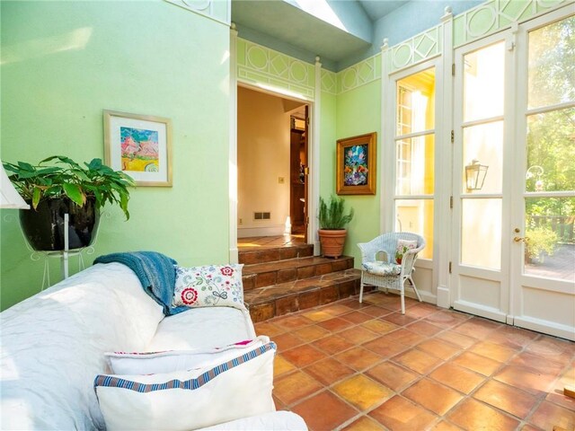 living room featuring a healthy amount of sunlight and tile patterned floors