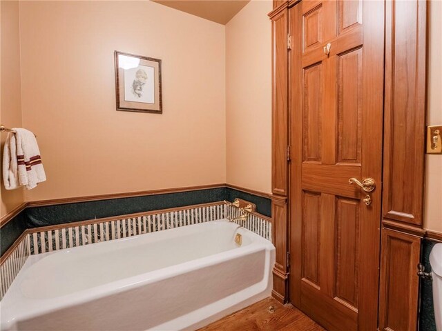 bathroom featuring hardwood / wood-style floors and a bathing tub