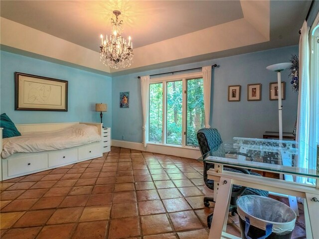 bedroom featuring a raised ceiling, a chandelier, and tile patterned floors