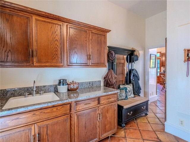 kitchen with sink and light stone countertops