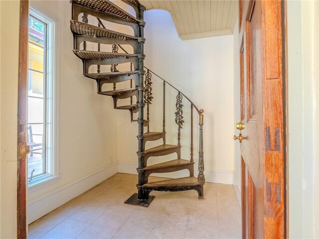 stairway with tile patterned floors