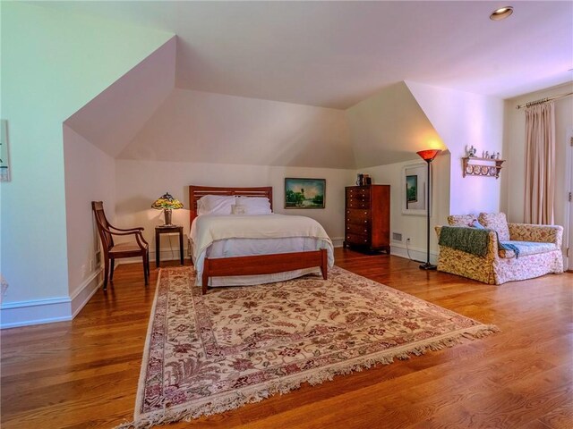 bedroom featuring lofted ceiling and hardwood / wood-style floors