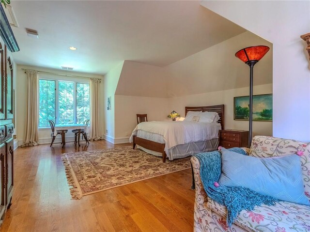 bedroom featuring vaulted ceiling and hardwood / wood-style flooring