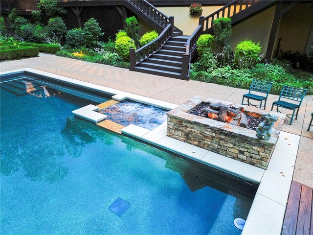 view of pool with an outdoor fire pit and a patio area