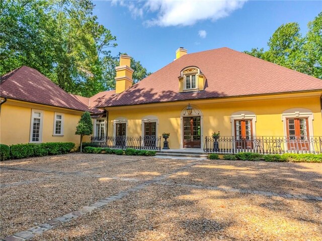 rear view of house with covered porch