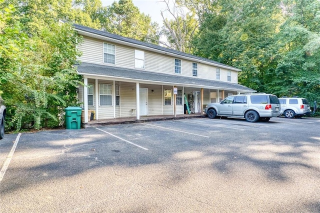 view of front of home featuring covered porch and uncovered parking