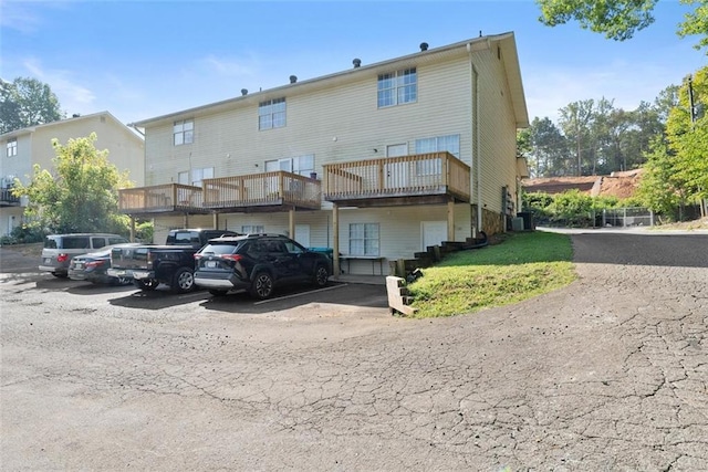 rear view of property featuring uncovered parking