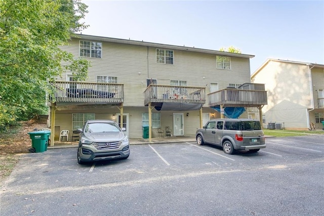 rear view of house with uncovered parking