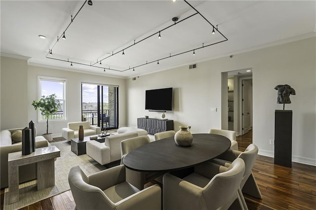 dining area with visible vents, baseboards, and wood finished floors