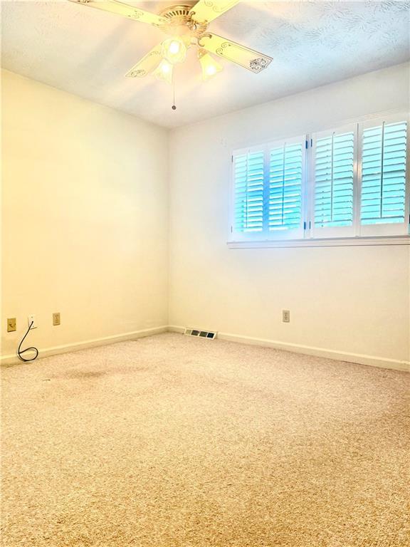 10 Montre Cir, Silver Creek, GA 30173 - empty room with carpet and ceiling fan