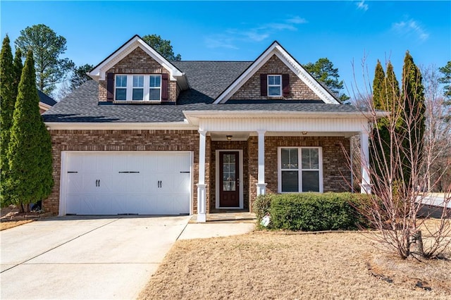 craftsman-style house with brick siding, a shingled roof, concrete driveway, covered porch, and a garage