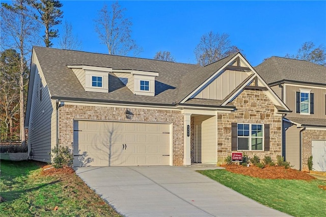 craftsman house with a garage and a front yard