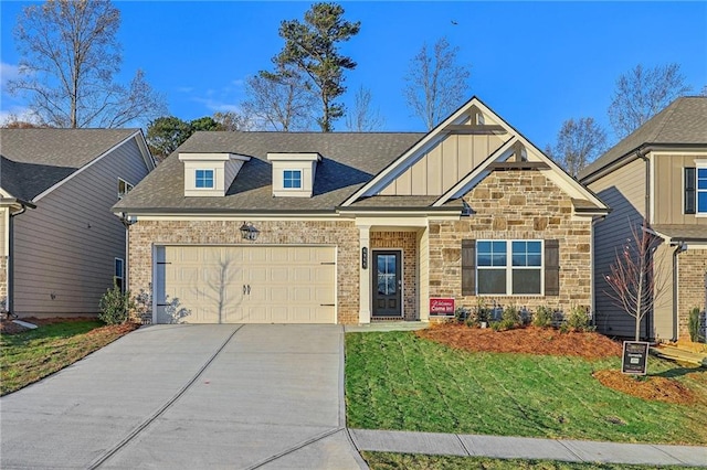 view of front of home featuring a garage and a front lawn