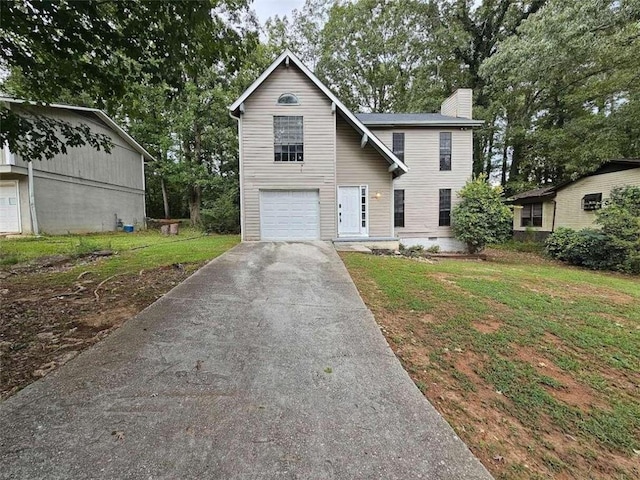 view of front of property with a garage and a front lawn